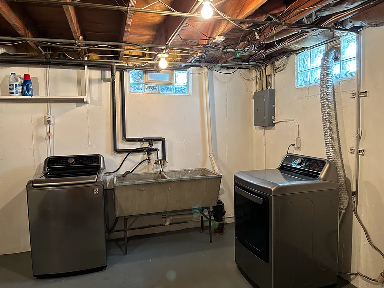 Laundry room fully equipped with washer and dryer
