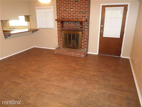 DEN With wood burning fireplace. Open bar to kitchen. Wood a
