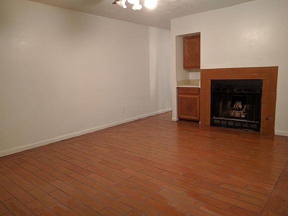 Large living room with fire place and brand new floor cerami