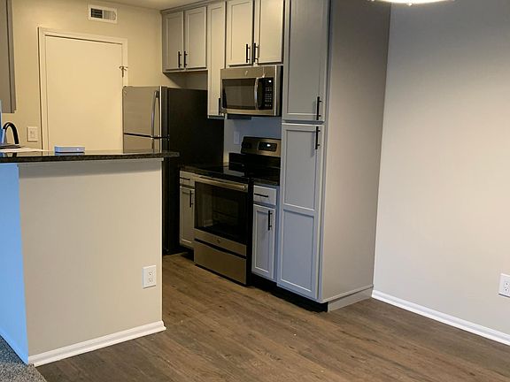 View of living room. Gray to the ceiling cabinets. Stainless Steel Appliances. BRAND NEW!