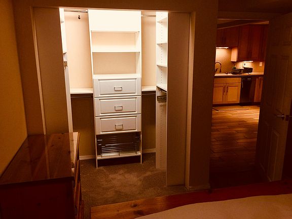 Open walk-in closet with loads of space to store clothes.