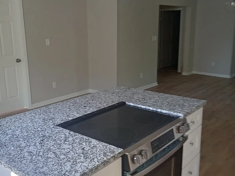 Upstairs Kitchen island with flattop stove and soft close cabinetry.

Downstairs unit extremely similar.