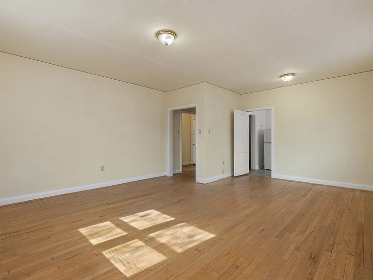 Bedroom with hardwood floor and bright windows