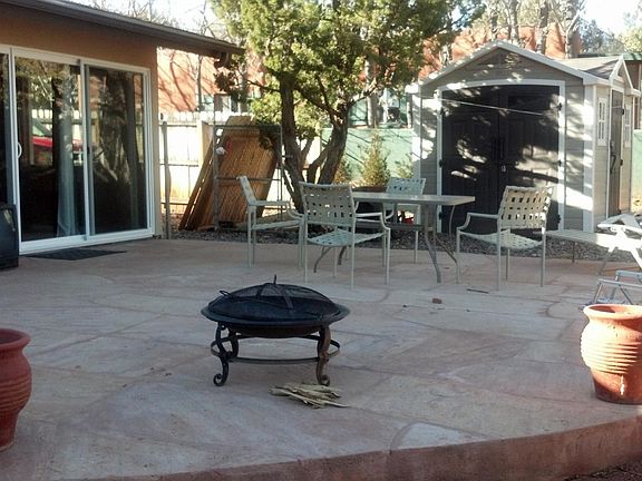 Back of house showing flagstone patio and shed.