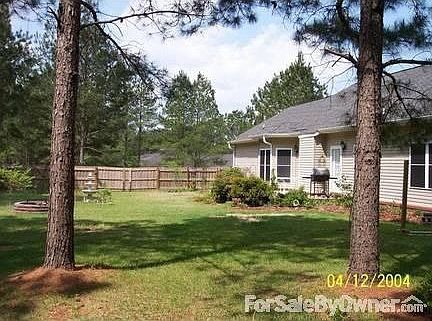 fenced backyard with cement patio