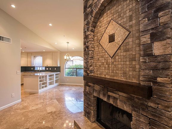 Living room fireplace towards kitchen and breakfast area.