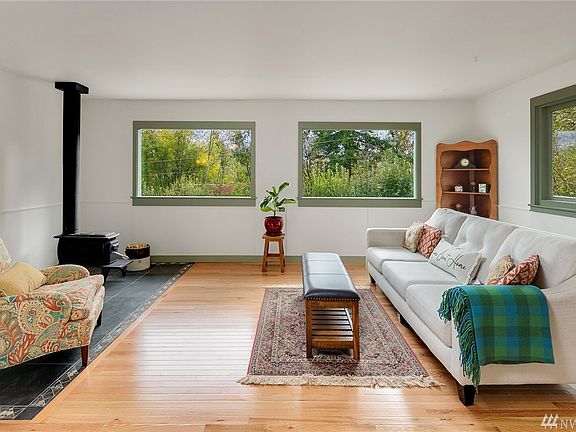 Oak floors, cozy wood stove on slate hearth. Lovely, verdant views to the south. This room is generous and serene.