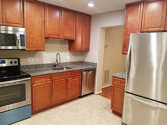 remolded kitchen with large cabinets and granite counter top