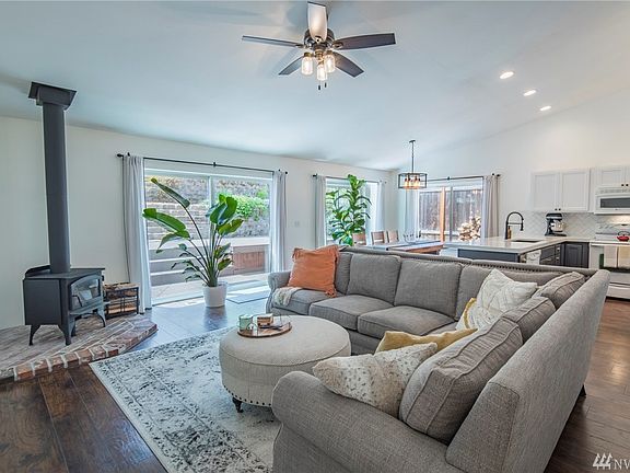 Fantastic remodel with open floor plan! Gorgeous laminate wood flooring, new wood burning stove with brick hearth. Lots of windows here for natural light.