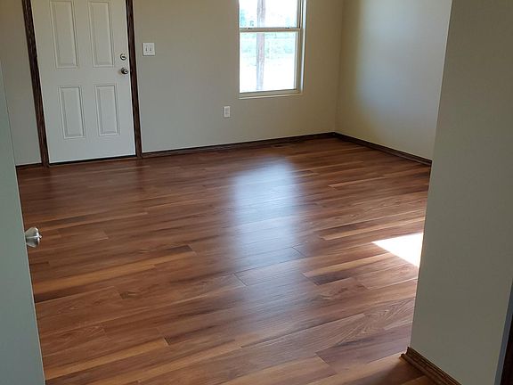 Living room. New vinyl plank flooring. Custom blind to come.
