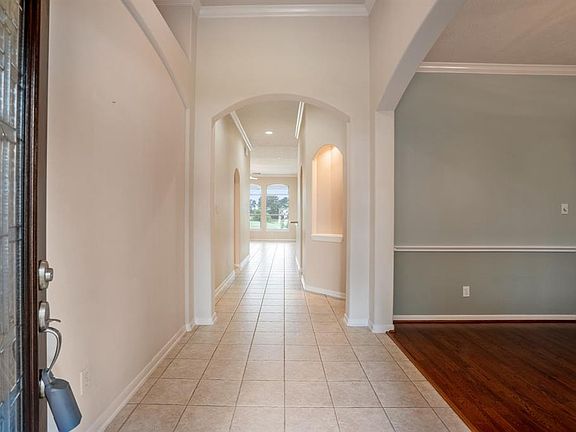 Upon entering the home, you'll notice the architectural detailing that includes arched walkways, art niches, recessed lighting and crown molding! Also easy to maintain ceramic tile flooring that flows down the hallway into the fabulous kitchen!