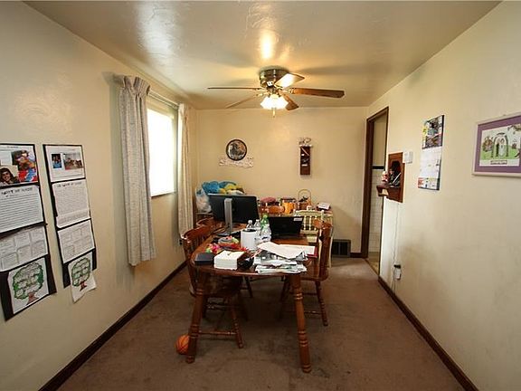 Nice 11x8 Dining Room w/ Ceiling Fan Light & Front Window calling in the Natural Light.Door in photo leads into Kitchen, picture