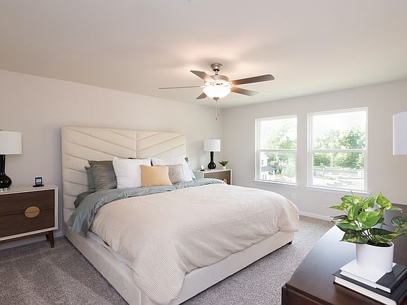 Unwind in the private primary suite, located upstairs.