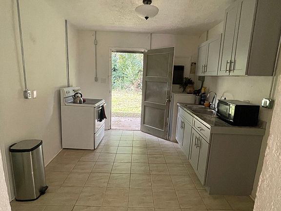Newly renovated kitchen, leads to back patio area.