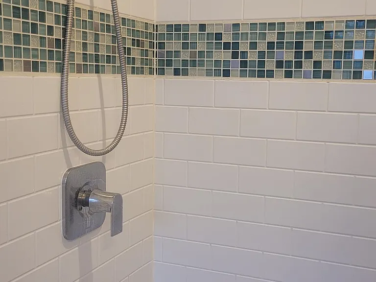 Glass tile accent in tub area of master bath shower
