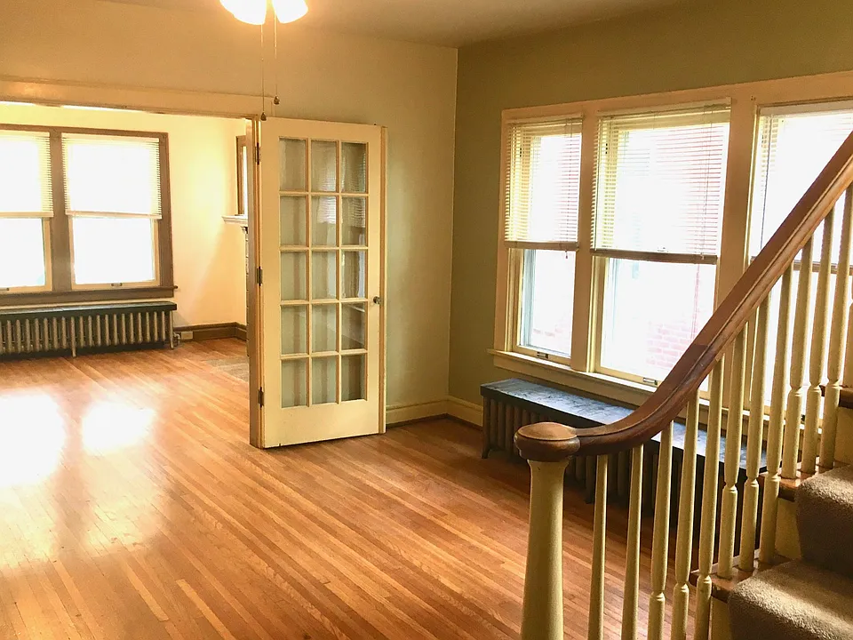 View of dining and living rooms. Beautiful hardwood, tall windows, and high ceilings throughout.