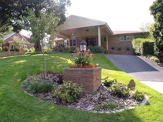 Front exterior with wide portico to keep guests dry in wet weather.