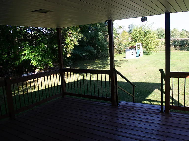 Covered wood deck just off of the living room.