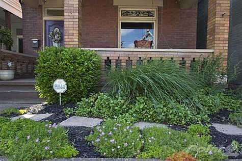 Front garden with stone walkway & covered front porch