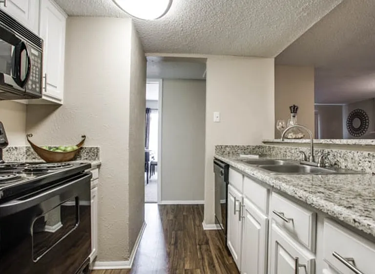 Bright, functional kitchen with extended counter space and seamless flow into the dining area.