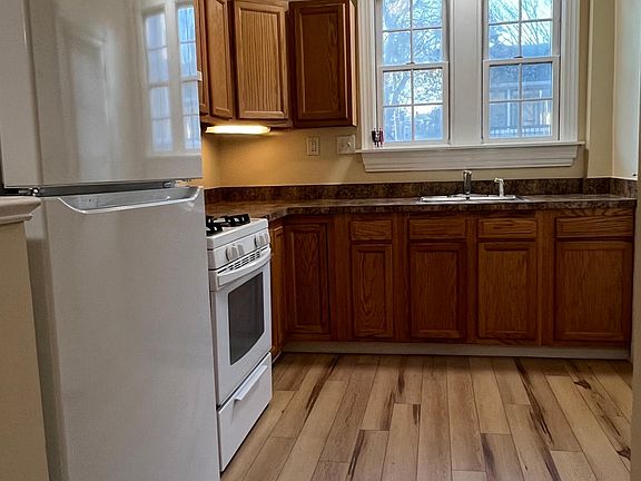 Kitchen with new refrigerator, new flooring & new light fixtures