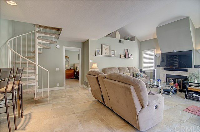 Living Room with spiral staircase to Spacious Loft