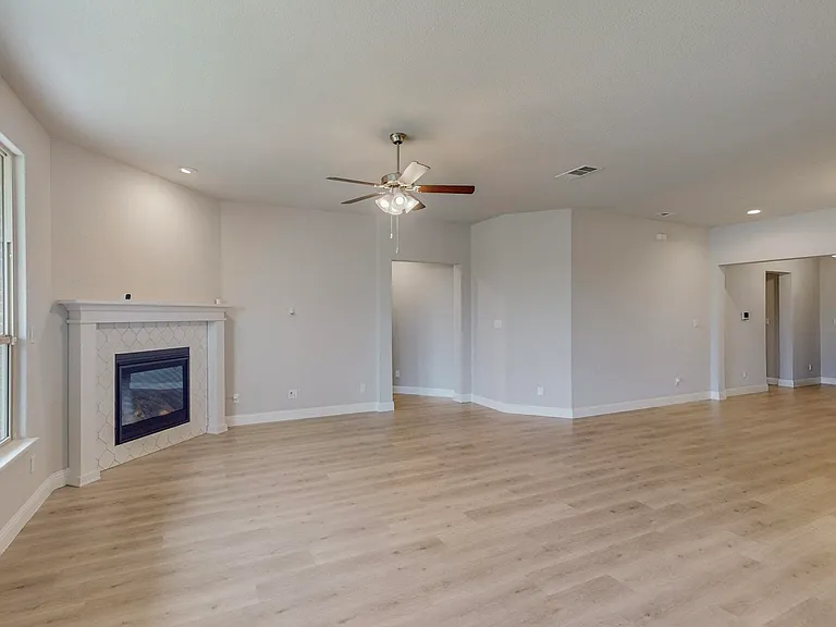 This living area features light wood-like flooring for a bright and airy feel
