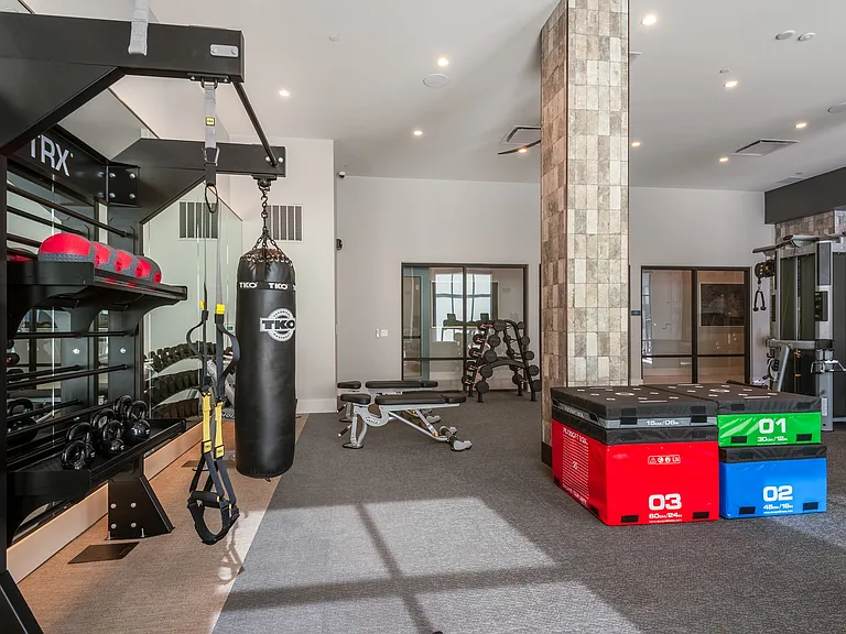 Well-Equipped Resident Gym with TRX, Weights, and Training Benches