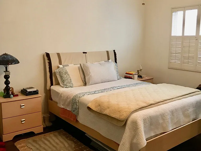 Primary bedroom; hand scraped wood floors, original vintage shutters
*newly installed ceiling fan not pictured