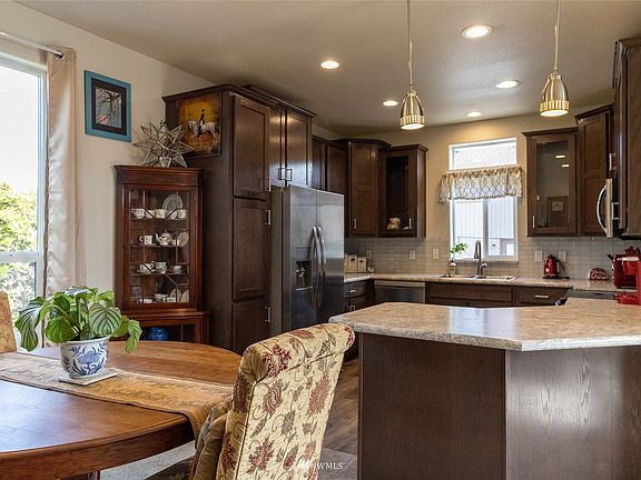 view from dining to kitchen. All appliances stay. Gorgeous cabinetry. >