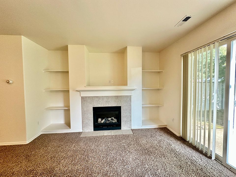 Electric fireplace with shelves for decoration or storage.