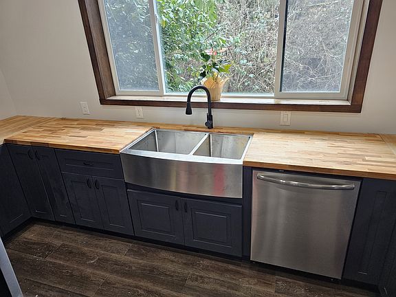 Farm sink with disposal. Frigidaire "Gallery" dishwasher. Butcherblock countertops.