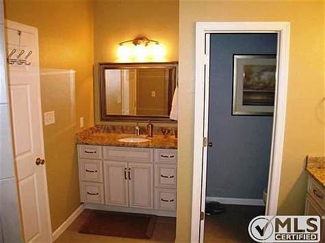 Separate sink and vanity areas with exotic granite.