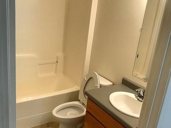 Bathroom has hand held shower nozzle. 5 ft by 6 ft.