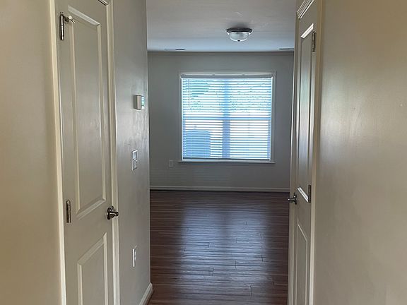 Entry through front door. Half bath to the left, utility closet door to the right.