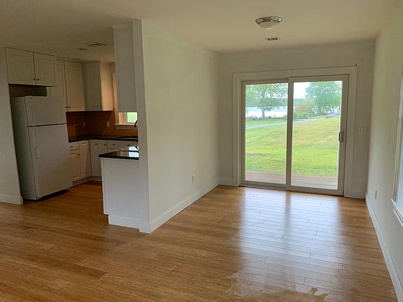 Open living/dining/kitchen area with nice views of Long Pond from inside and out!