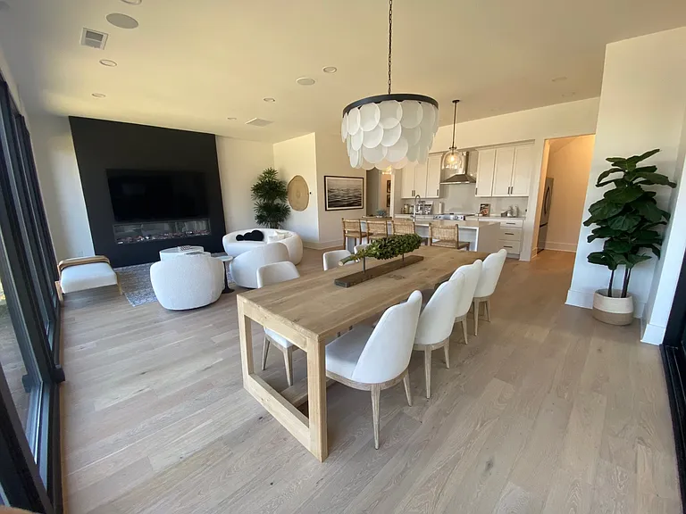 Dining to kitchen and living area, includes a full screen TV