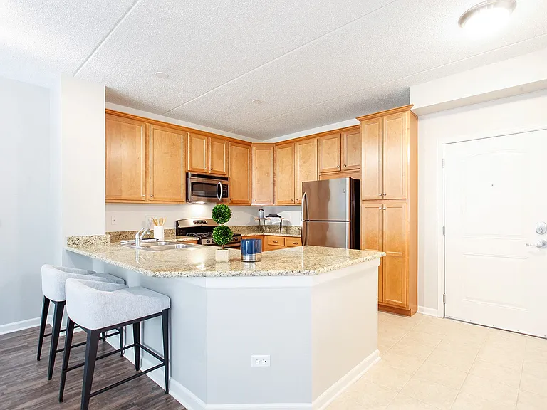 U-shaped kitchen with granite countertops and wood cabinetry