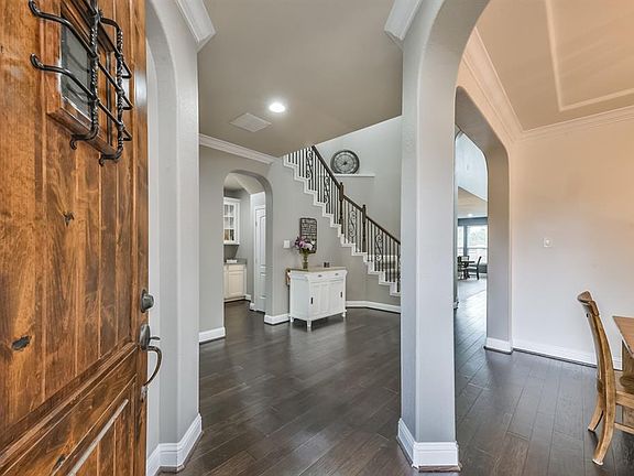 Enter through the solid wood front door into the welcoming foyer. The engineered wood floors were recently installed in the foyer, dining and master bedroom.
