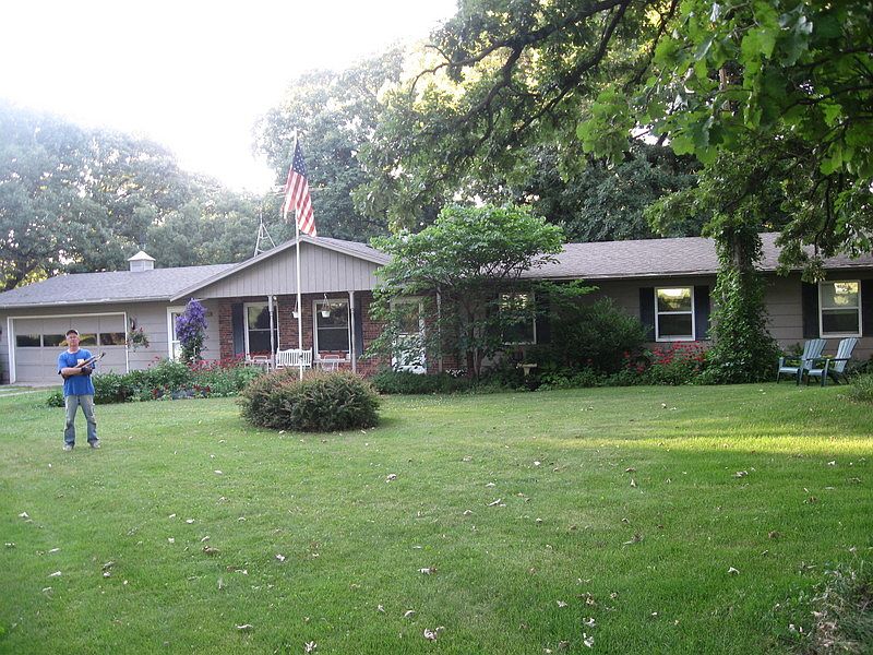Mature trees surround the house