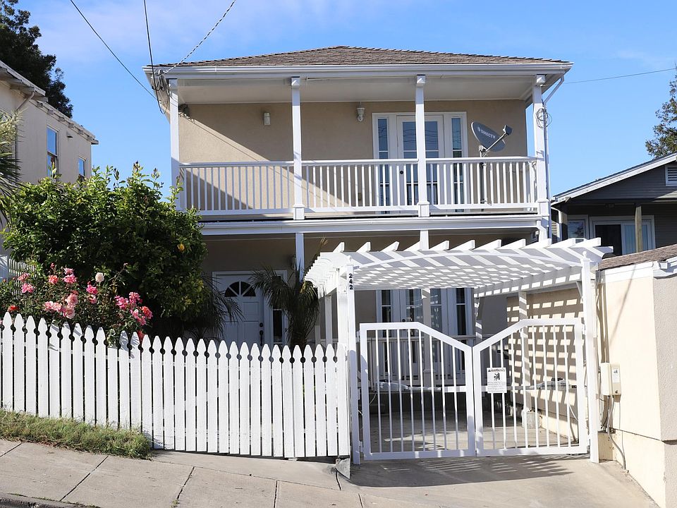 Roses and lemon tree shade the front pathway