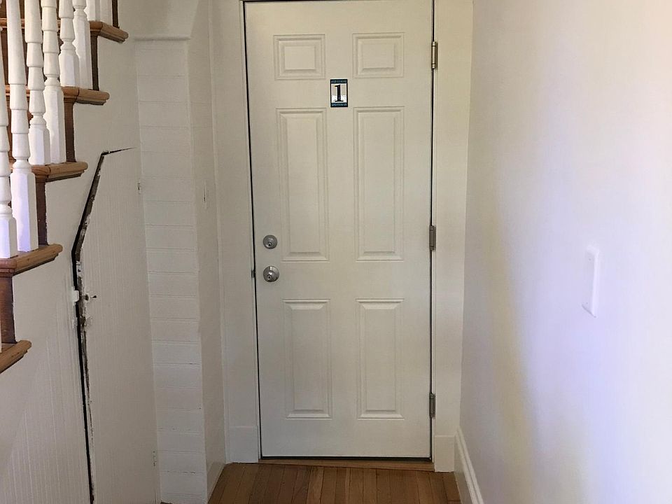 Entry way just inside external front door; stairs go up to units 2 and 3.