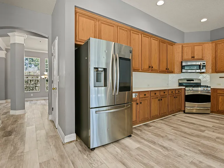 Kitchen with pantry behind kitchen in hall and access to dining