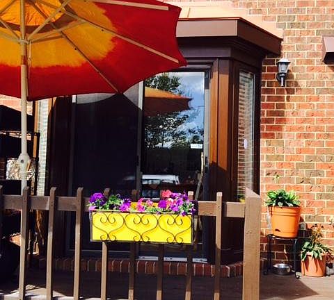 Back deck off the kitchen and in front of designated parking space.
