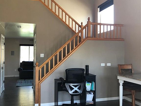THIS VIEW FROM FRONT ENTRANCE, SHOWS BANISTER GOING TO SECOND LEVEL AND ENTRANCE TO FAMILY ROOM.