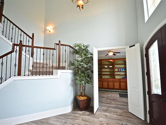 To the right of the entry is a large study with built in bookcases. Gorgeous wood like tile floors thru out the whole down stairs!!