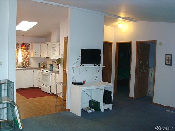 view at front door, large living area, kitchen with eat in dining area and 2 secondary bedrooms and full bath to the right.  Add some new carpet and some flooring in both bathrooms to make it look new again