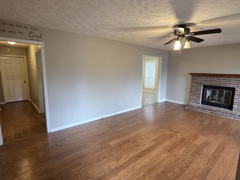 Living room with fireplace and ceiling fan