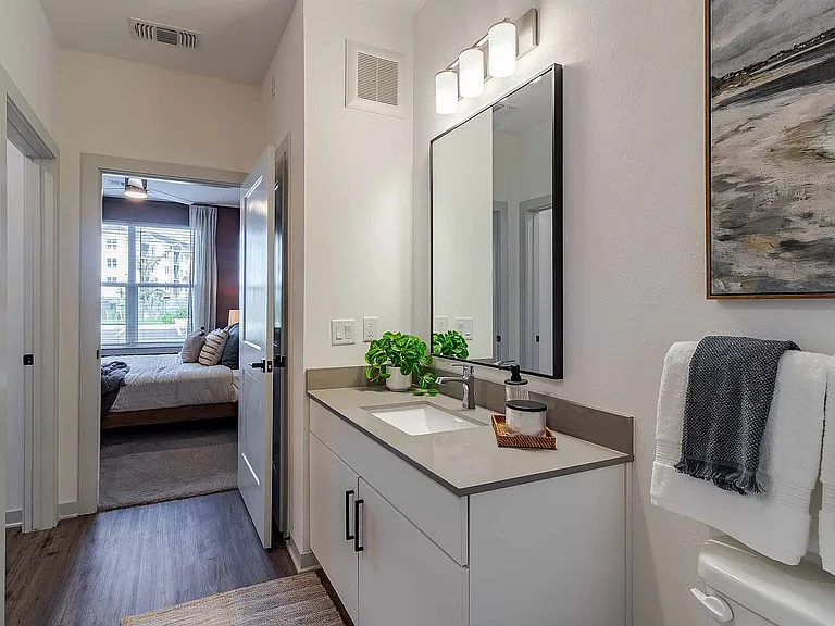 Get ready in style at the quartz-topped vanity, thoughtfully positioned just off the bedroom for an easy everyday flow.