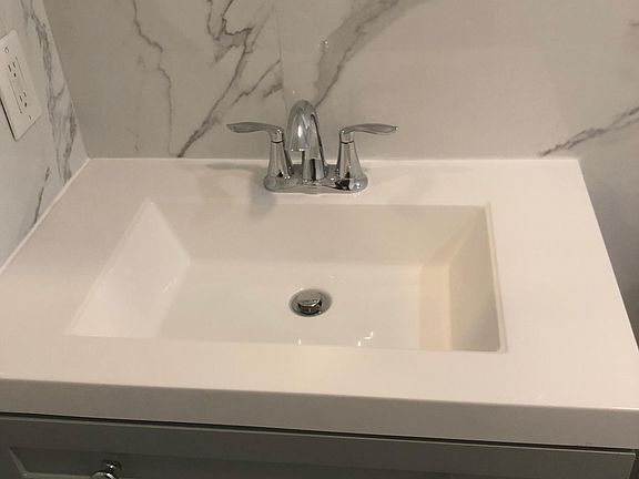Large sink with brushed chrome fixtures.